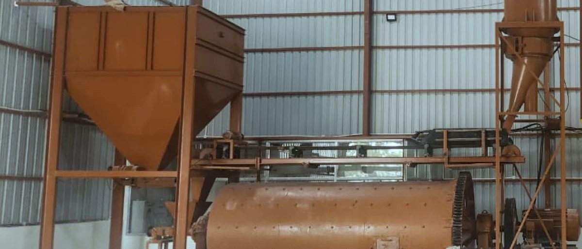 Ball mill shell and feed hopper in red-oxide primer on the works floor