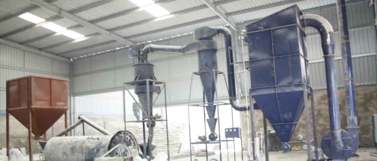 Micronizer plant with sacks of finished powder stacked on the floor beside the line