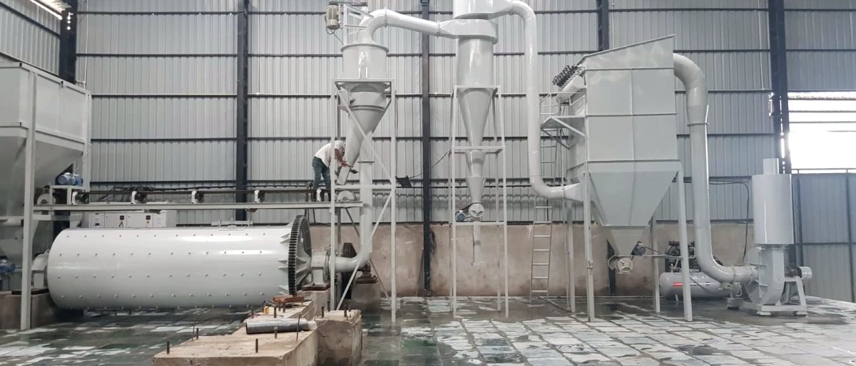 Micronizer plant with the ball mill shell in the foreground and the cyclone stack behind